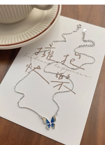 Detail of S925 silver butterfly necklace with blue gradient enamel and micro diamonds