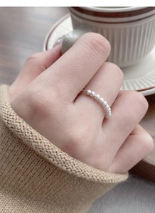 Close-up of S925 sterling silver frosted beaded open ring worn on a finger