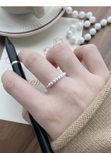 Detailed view of matte S925 silver beaded open ring on finger in a refined setting
