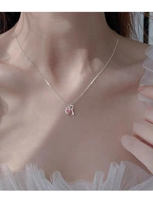 Detail of S925 silver necklace featuring a pink heart lock and key pendant on model
