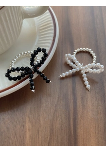 Macro shot of handmade S925 silver elastic bead ring with black and white butterfly charms