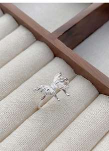 Detailed close-up of 925 sterling silver butterfly ring with small white crystals