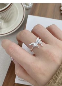 Detailed close-up of a 925 sterling silver butterfly ring featuring sparkling zircon accents