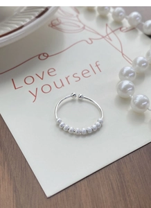 Detail of adjustable S925 silver ring with ten frosted beads on a Love yourself card