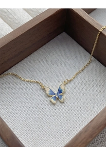 Detail of S925 butterfly necklace showing blue enamel finish and sparkling diamond center