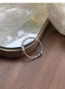 Detail of adjustable S925 silver ring featuring rotating frosted and polished beads