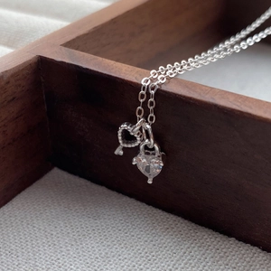S925 Sterling Silver Heart Key Necklace with Clear Zircon Pendant on Wood Display