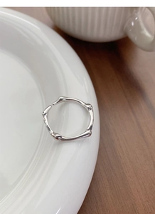 Macro shot of S925 sterling silver ring showing irregular texture and polished finish
