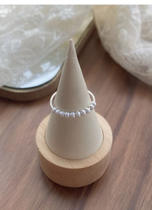 Detailed view of matte S925 silver beaded ring on a premium jewelry display stand