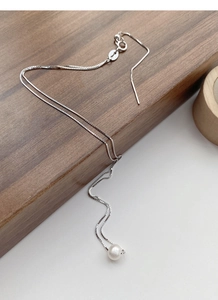 Detailed macro view of S925 silver box chain with a round white freshwater pearl