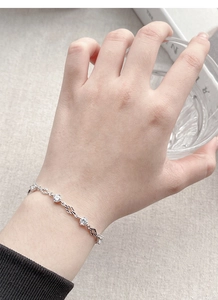 Detail of S925 silver bracelet with sparkling zircon stones and hollow diamond links