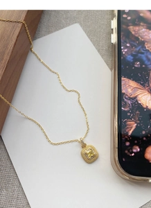 Macro detail of S925 silver square sugar necklace with yellow gem and gold finish