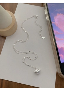 Detail of S925 sterling silver heart necklace with double-layer chain and small sequins