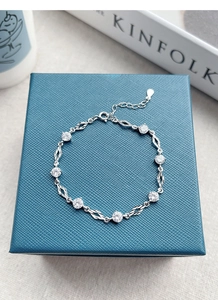 Detailed view of S925 silver bracelet with white zircon and heart-pendant extension chain