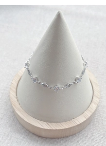 Detail of S925 sterling silver bracelet with twisted metal links and clear zircons