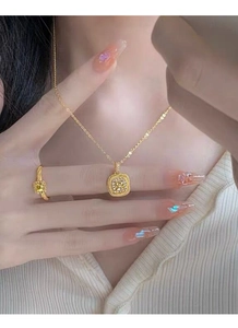 Detail of square yellow crystal necklace and textured ring on model with white knitwear
