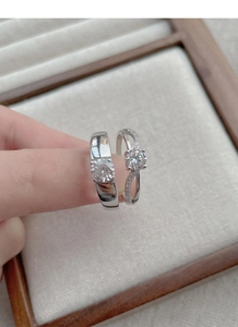Close-up of S925 sterling silver couple rings set featuring classic solitaire and pavé design