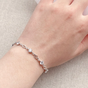Elegant S925 sterling silver bracelet with sparkling zircons on a linen background