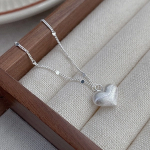 S925 sterling silver brushed heart pendant necklace on an elegant jewelry tray