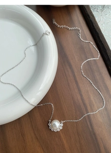 Detail of S925 sterling silver necklace showing white pearl and sparkling zircon pendant