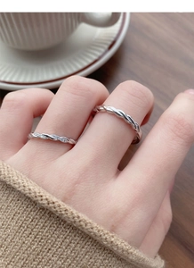 Detail of S925 silver Mobius rings featuring twisted texture and pavé zircon settings