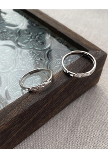 Macro detail of interlocking S925 sterling silver rings with geometric facets and zircons