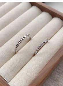 Detailed view of S925 silver Mobius rings with twisted design and pavé settings