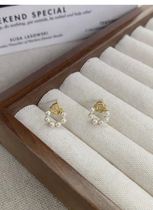 Détail des boucles d'oreilles rétro en argent S925 avec rose et perle sur écrin
