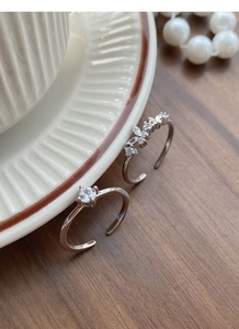 Macro detail of S925 sterling silver adjustable rings with marquise cubic zirconia clusters