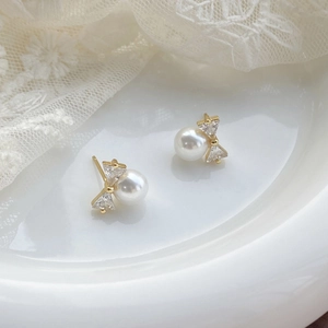 Elegant S925 silver bow stud earrings with white pearls and gold metal finish