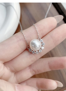 Macro shot of S925 sterling silver pearl necklace with shimmering zircon pendant details
