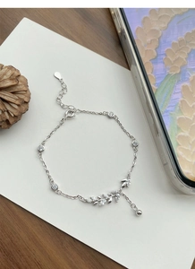 Close-up of S925 sterling silver wheat ear bracelet with cubic zirconia and fringe tassel