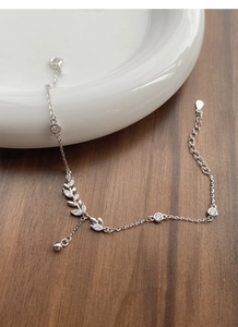 Close-up of S925 silver wheat ear bracelet with cubic zirconia on a white plate