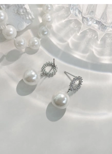 Détail de boucles d'oreilles en argent S925 avec zircons et grandes perles blanches