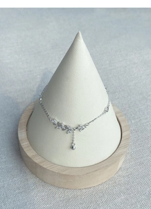 Detail of S925 silver wheat ear bracelet with leaf zircons and ball tassel on stand