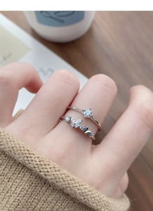 Close-up of stacked S925 silver rings with zircon butterfly and minimalist band details