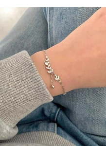 Close-up of S925 silver wheat ear bracelet with marquise-cut stones and tassel charm