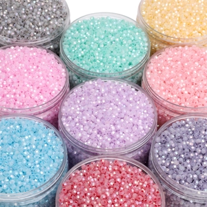 Macro view of colorful 4mm faceted glass beads in clear jars for DIY jewelry making
