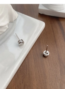 Detail of S925 sterling silver stud earring showing S925 hallmark and bezel-set zircon