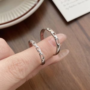Interlocking S925 sterling silver chain rings for couples shown on hand with zirconia accents
