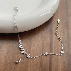 Elegant S925 sterling silver wheat ear bracelet with cubic zirconia leaves on ceramic tray