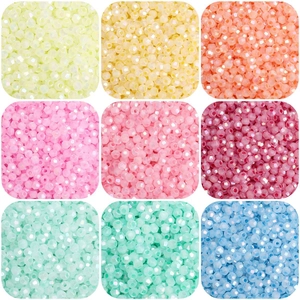 Macro detail of 4mm faceted glass seed beads in nine vibrant colors for DIY jewelry