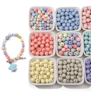Macro view of macaron colored acrylic beads set for DIY jewelry with star charm
