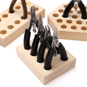 Macro detail of natural pine wood pliers storage rack with organized deep round slots