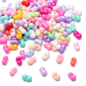 Cuentas de vidrio de colores con forma de lazo para bisutería DIY sobre fondo blanco