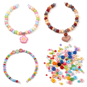 Macro detail of colorful glass seed beads with flower and heart charms for DIY jewelry