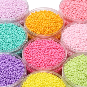 Colorful rainbow glass seed beads in transparent containers for DIY jewelry making