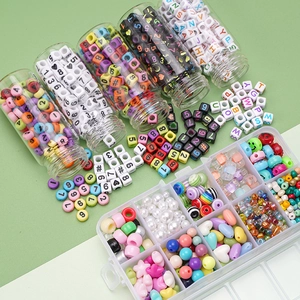 Detail showing DIY bead kit with letter beads, colorful shapes and glass jars for jewelry