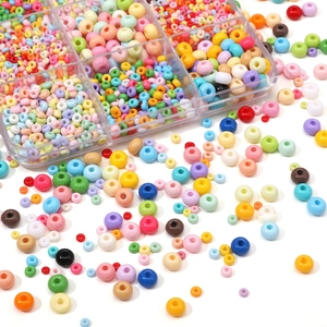Macro shot of assorted colorful glass seed beads with clear multi-grid storage box