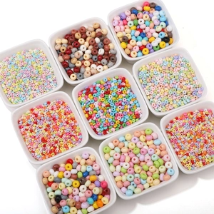 Colorful glass seed beads collection in white bowls for DIY handmade jewelry crafting